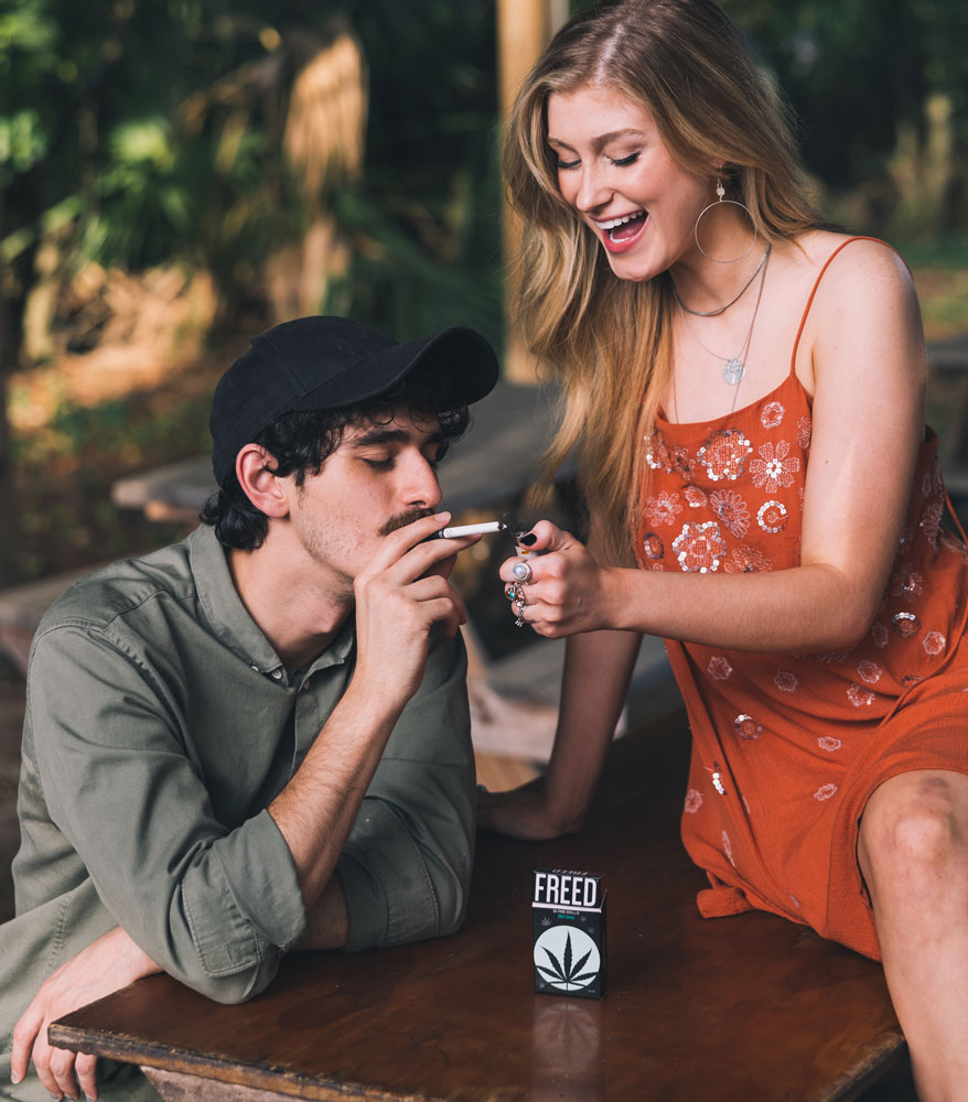 girlfriend lighting a FREED pre roll for her boyfriend